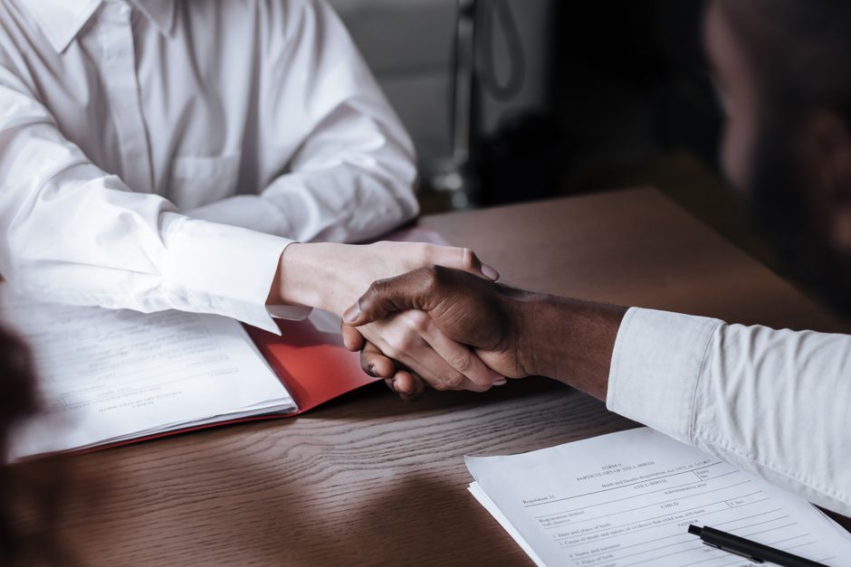 Property manager reviewing a security company proposal with a licensed guard in a BC office, illustrating how to choose security companies in BC
