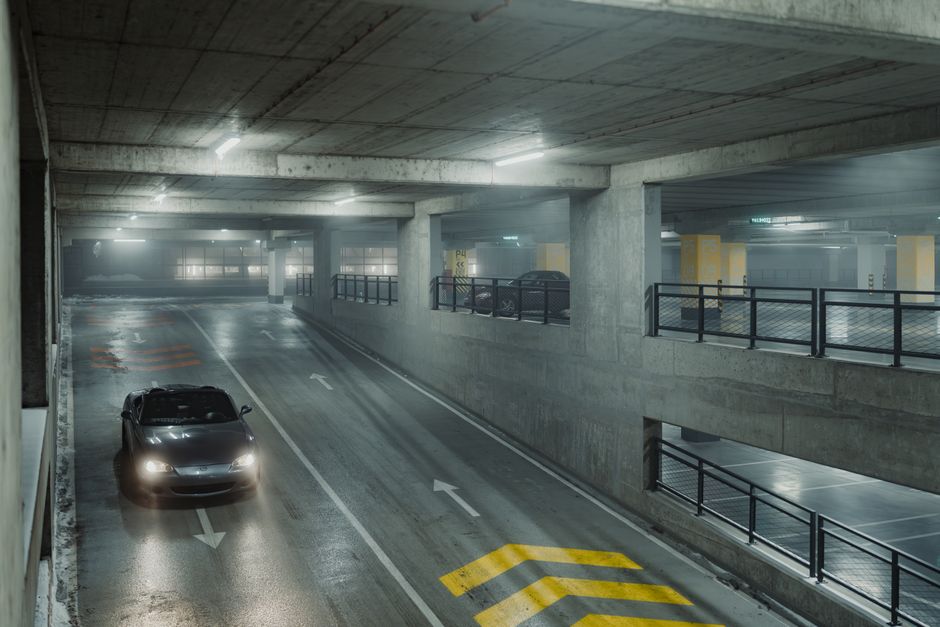 Security officer patrolling a well-lit parking lot in Surrey BC in the evening