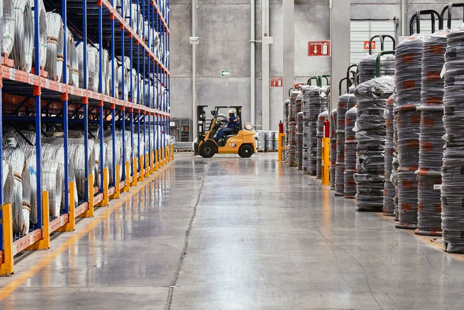 Security guard checking a truck driver's paperwork at a warehouse loading dock in Surrey BC